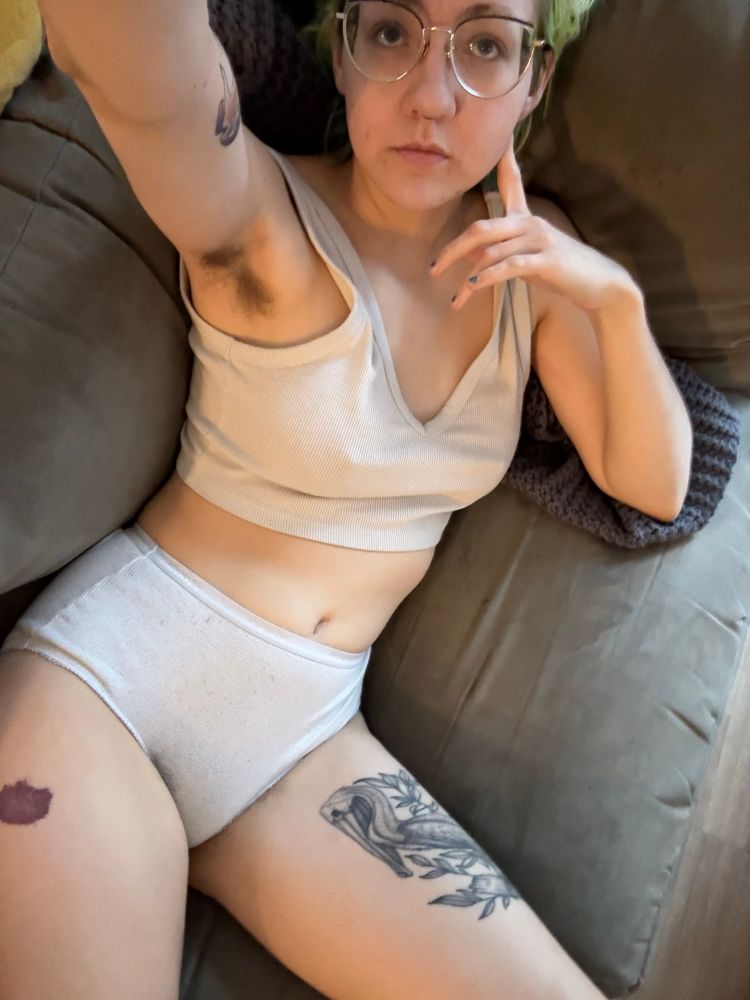 sable laying on the couch in a white cropped tank top and white high-waisted undies