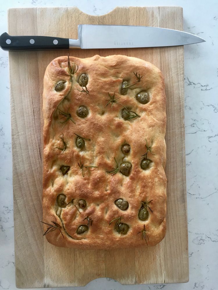 Focaccia bread on a chopping board.