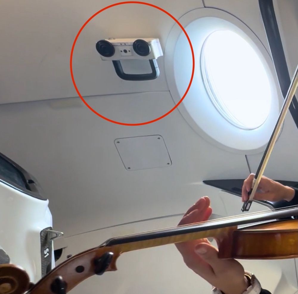 LLAMAS payload hard-mounted to the interior of Crew Dragon Resilience. LLAMAS is a white box with two wide field of view lenses that make it look a bit like a face. A mobility aid is mounted to the bottom. 