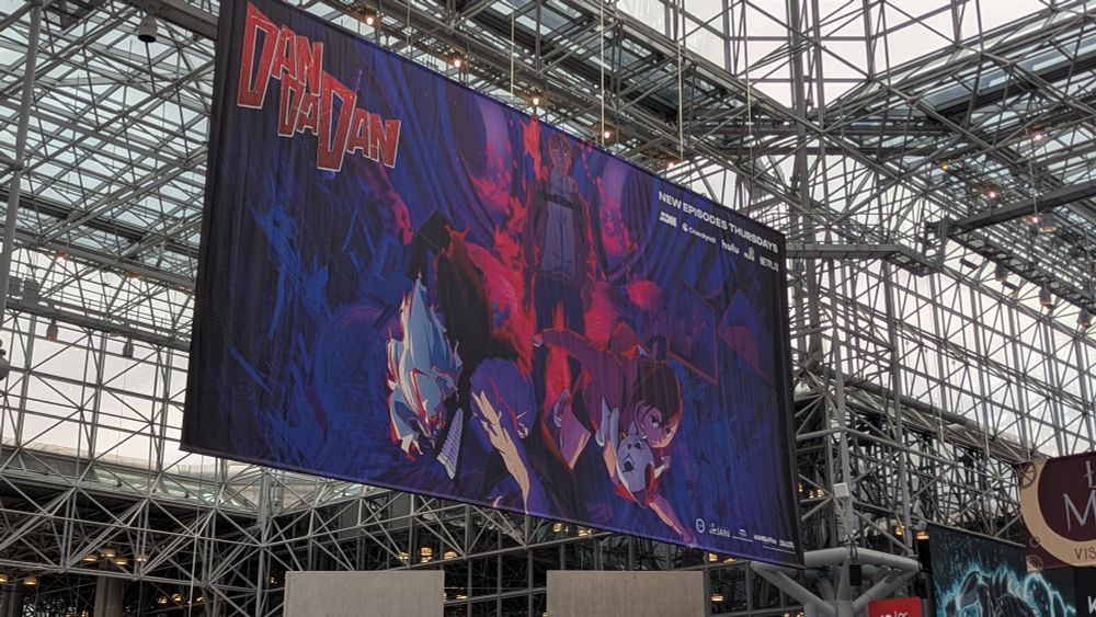 Dan Da Dan banner hanging from the ceiling at Javits. In the top right corner it says "New episodes Thursdays"