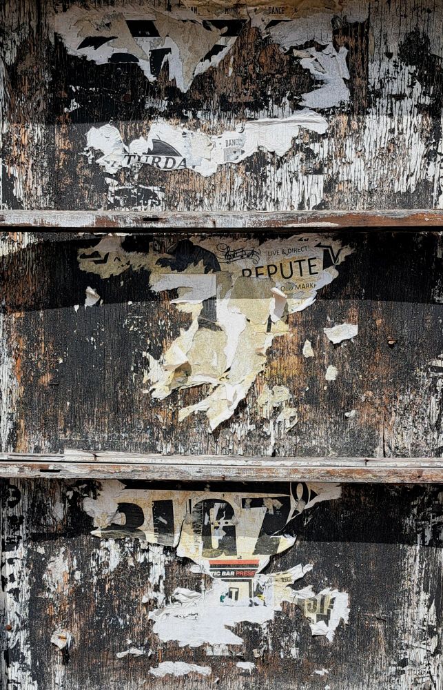 Fragments of posters in a wooden case