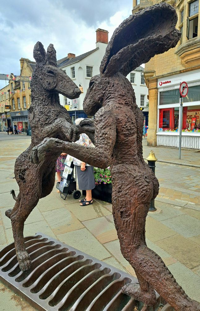 Sculpture of boxing hares in Cirencester, England.
