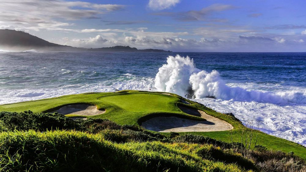 The short par 3 7th hole at Pebble Beach with waves crashing off shore.