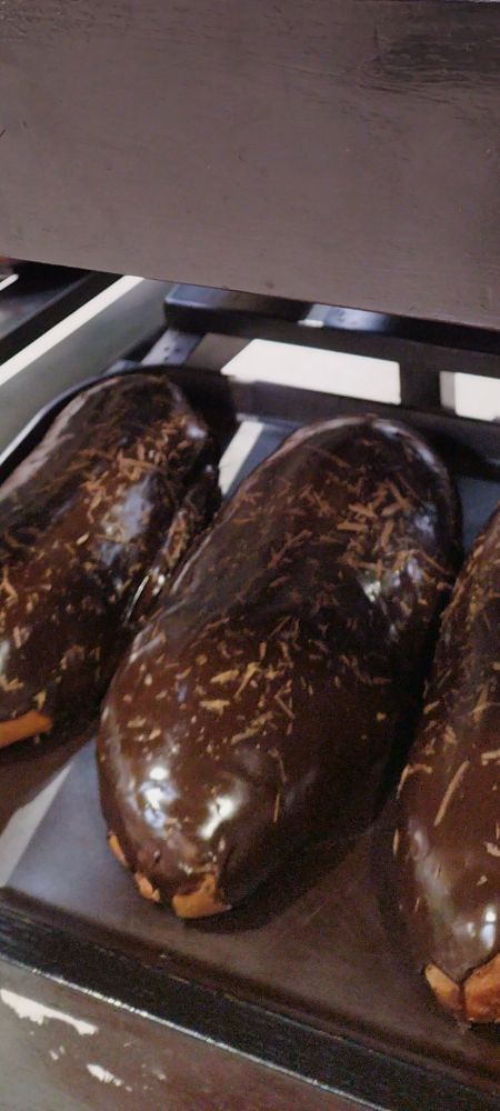 zoomed in pictures of a kind of sweet bread whose name i don't know, consisting of approximately 500 grams of sturdy bread filled by jam covered in chocolate by personal opinion it is delicious 