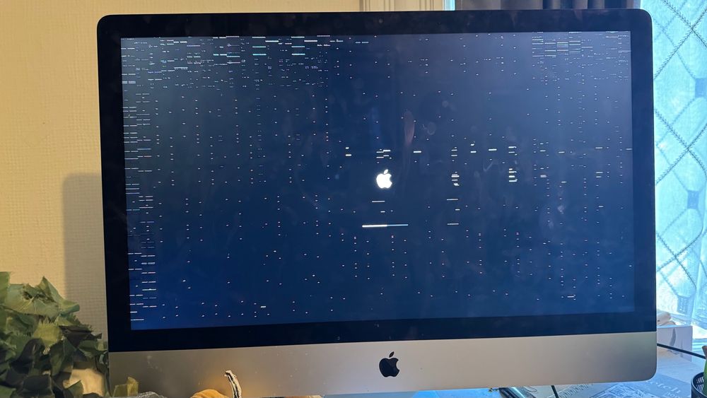 A photo of an iMac screen that is very glitchy. 