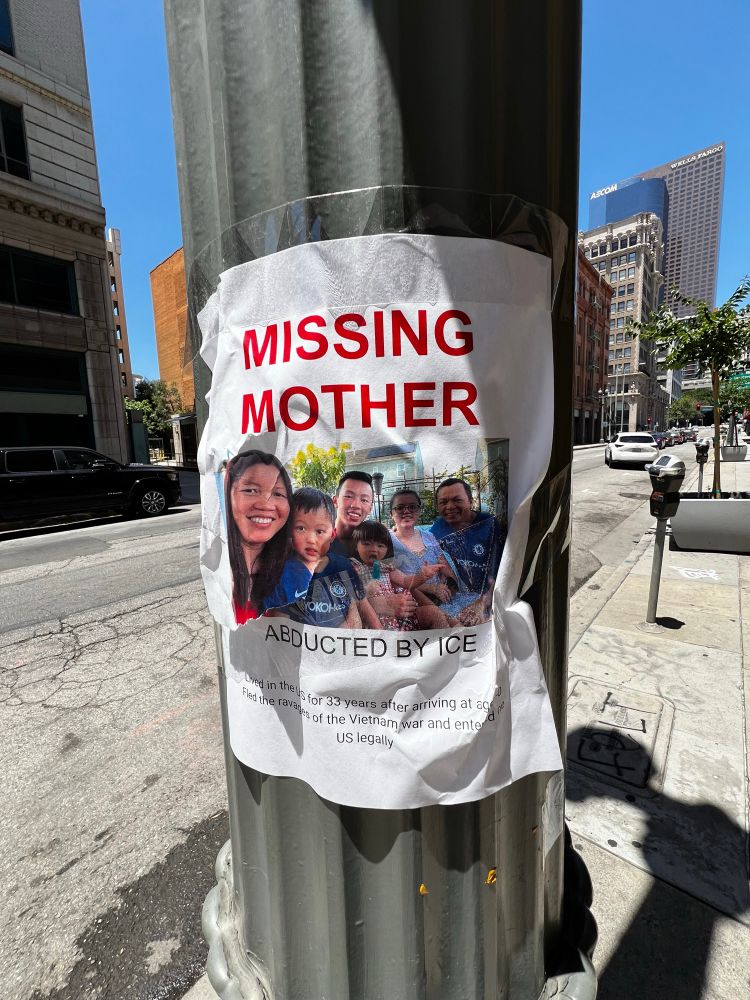 Poster reading MISSING MOTHER - ABDUCTED BY ICE, which a photograph of a smiling family.