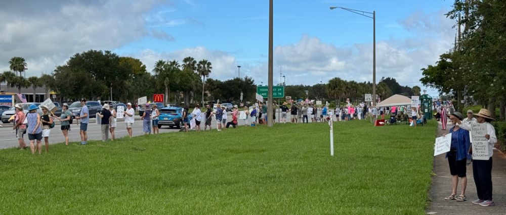 Resisters on parkway Vero Florida Labor Day many signs