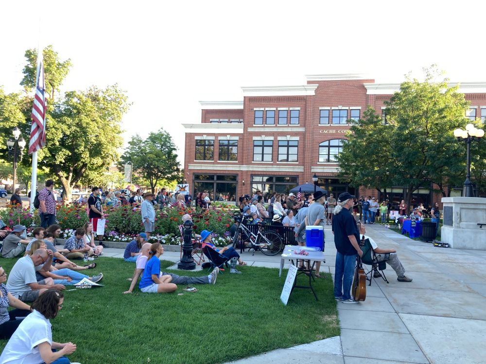 About 200 people listen to music, poetry, and speeches for. Labor Day rally in Logan, Utah.   The flag is at half staff in memory of the two police officers killed on a domestic violence call in Tremonton, Utah. 