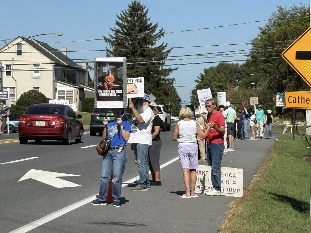 Protesters on roadside Allentown PA 
signs THIS IS HOW TO MAKE AMERICA GREAT
[ photo of rump in jail cell ]