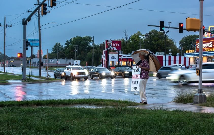 Intrepid Protester on street corner in the rain 21st and Gage Topeka KS TRUMP RACIST SINCE 1946