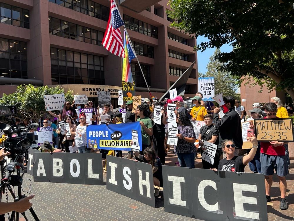Hundreds of Californians protest #PurgePalantir National Week of Action Edward J Schwartz Federal Building San Diego banner ABOLISH ICE - PEOPLE OVER BILLIONAIRES