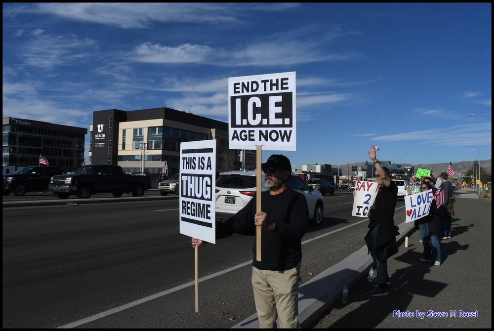 Resisters along roadside Salt Lake City UT
signs THIS IS A THUG REGIME - END THE ICE AGE NOW