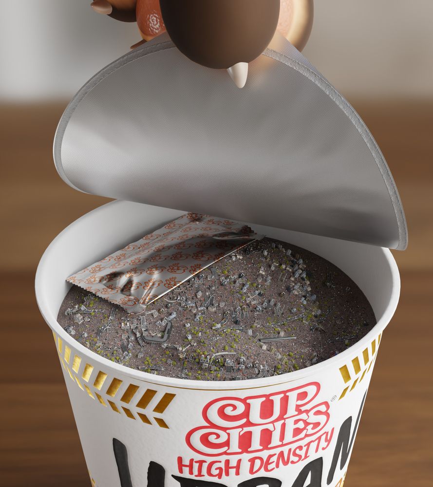 The lid of the cup is opened to reveal a mixture of gray powder, buildings and vehicles that doesn't resemble the picture on the label at all. There's also a spice packet inside the cup, labeled with little scared furry faces.