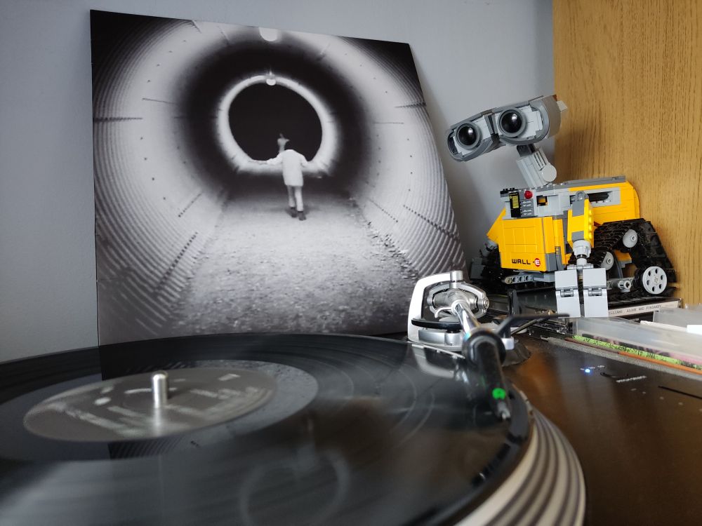 Music Inspired by Philippe Garrel's Le Révélateur by Mary Lattimore and Jeff Zeigler. A black vinyl LP on a Stanton turntable. Lego Wall-E looks on from the right of the picture.