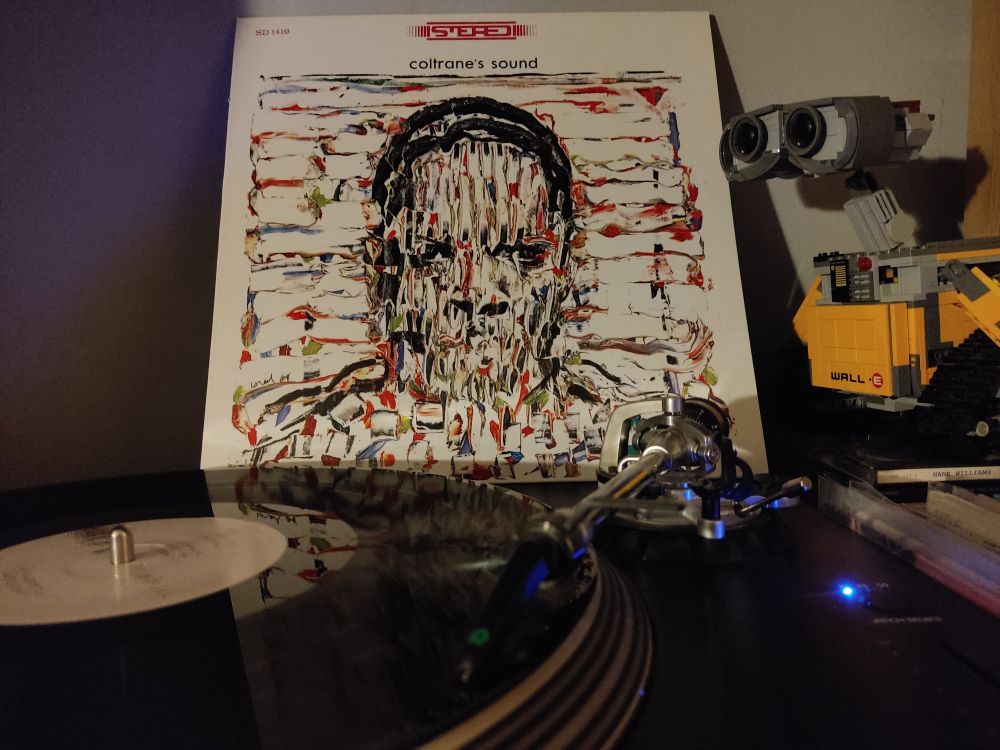 Coltrane's Sound by John Coltrane. A black vinyl LP on a Stanton turntable. Lego Wall-E looks on from the right of the picture.
