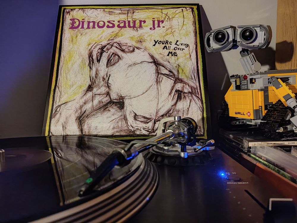 You're Living All Over Me by Dinosaur Jr. A black vinyl LP on a Stanton turntable. Lego Wall-E looks on from the right of the picture. 