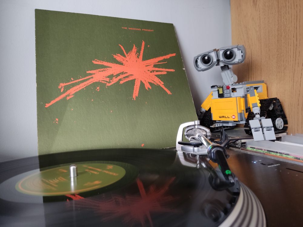 Bizarro by The Wedding Present. A black vinyl LP on a Stanton turntable. Lego Wall-E looks on from the right of the picture.