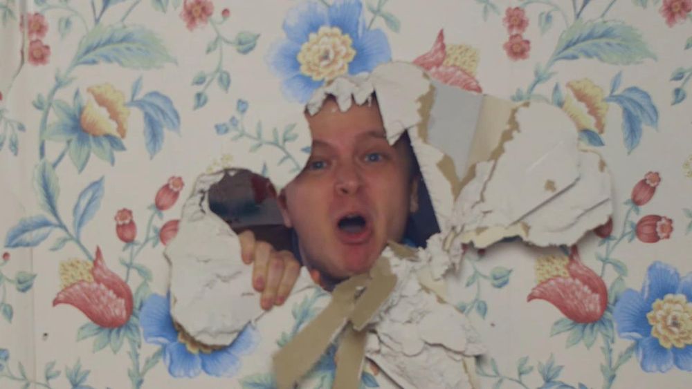 The “sell their houses to who, Ben?” Meme with  man’s face poking through a hole in the wall