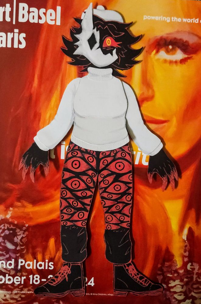 A detailed paper doll of Folly, an antagonist from the game Regretevator. She is a humanoid character who is solid black in color, with medium length, spiky hair, clawed fingers with red tips, and a single visible eye that is bright red with sharp lower lashes. The iris and pupil of her eye are made up of two bright yellow concentric rings.

She wears a white turtleneck sweater, a white beret on her head, black pants with realistic red eyes all over them, and black boots. On her face she wears a broken mask that resembles some sort of animal. The mask has a single, diamond shaped hole for an eye, three spikes on the outer edge that look like fur, and a single, tall ear pointing upwards. The missing piece of the mask reveals her eye.

The doll is displayed against a red, orange, and yellow background that is a poster for a Paris art show.