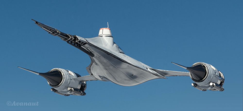 A white Naboo/Mandalorian N-1 starfighter photographed outdoors on a sunny say against blue sky. Low angle, below eye level, rear quarter view. 