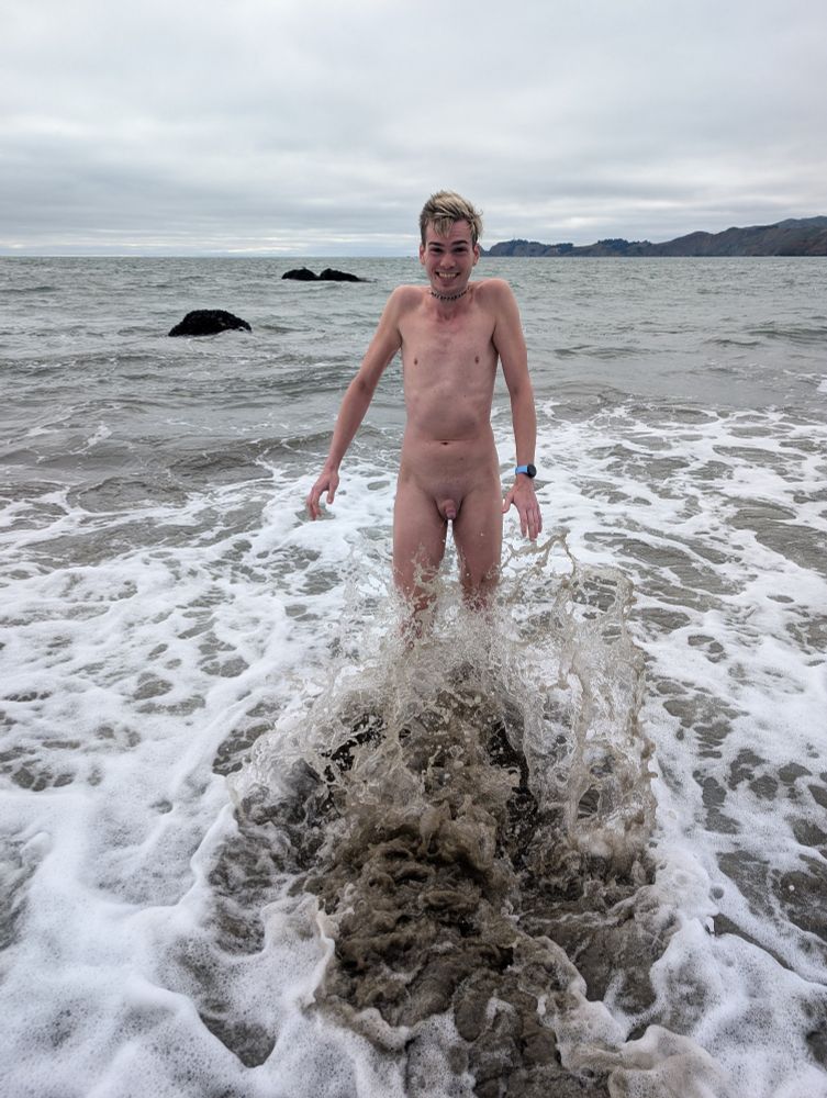 full frontal of me looking particularly shocked as a wave crashes against my legs from behind