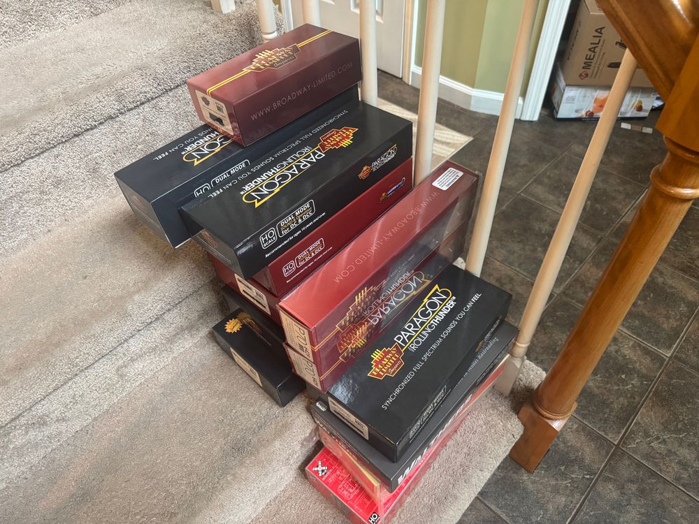 All of my HO-scale model trains tucked away in their boxes, stored on my stairs temporarily due to cleaning their shelves. It’s been a long time since I ran them, and I hope to bring them out to roam free again soon. 
