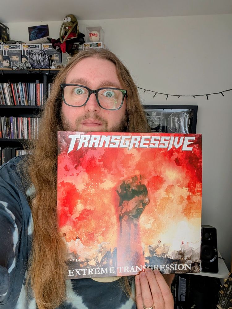 Alex is holding a vinyl copy of Extreme Transgression by Transgressive