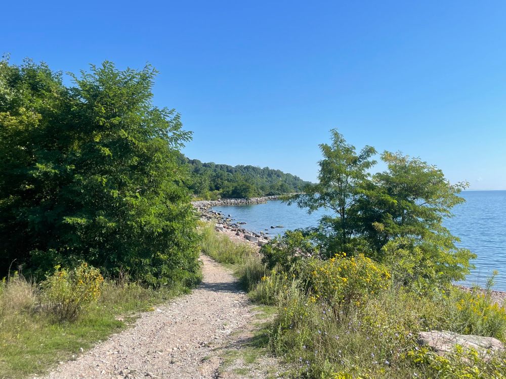 Photo of a gravel trail wending its way along the Lake Ontario shoreline at the Scarborough Bluffs in Toronto’s East End. 