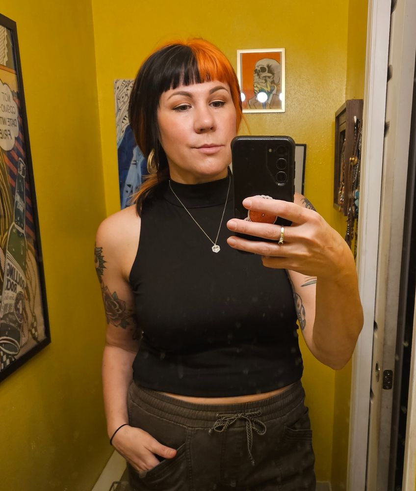 Black mock turtle neck and green pants