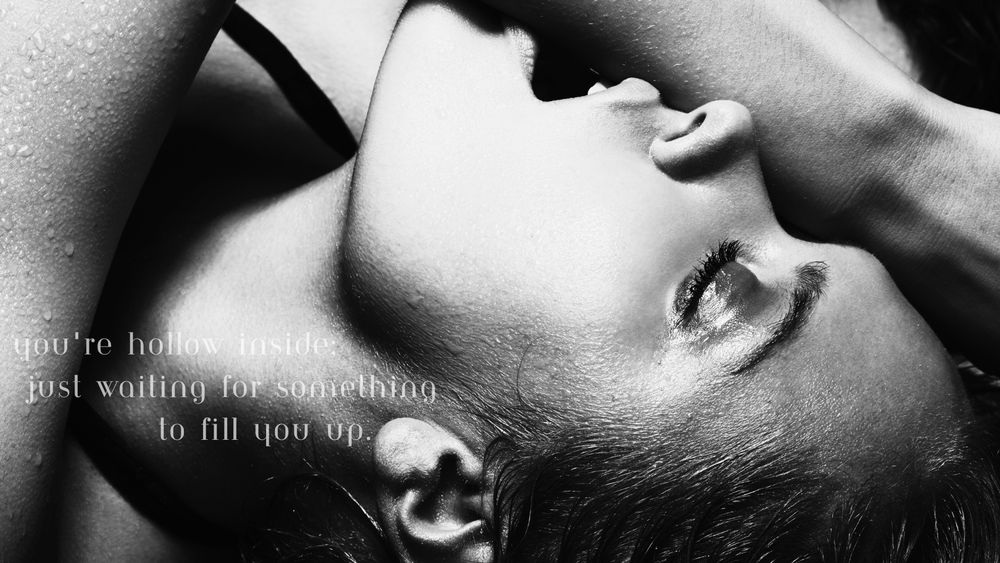 Woman in black and white biting her arm, text "you're hollow inside, just waiting for something to fill you up."