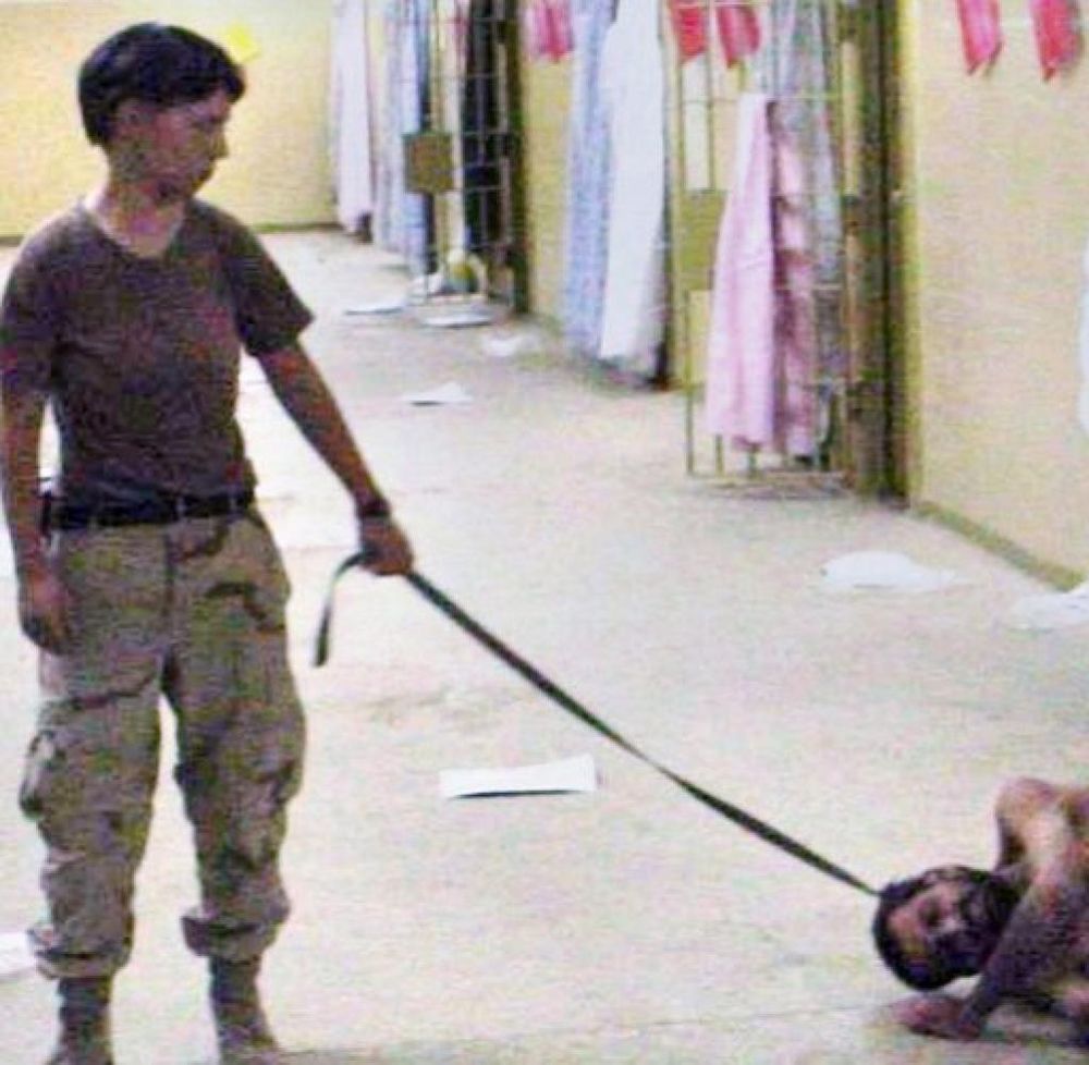 Lynndie England abusing an Iraq prisoner in Abu Ghraib in 2003