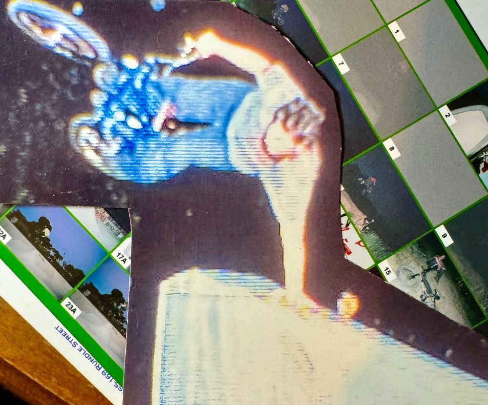 Bmx rider doing a stunt its me stunt is a handplant going upside down over a ledge using arm as point of ccontact at a skatepark at night 