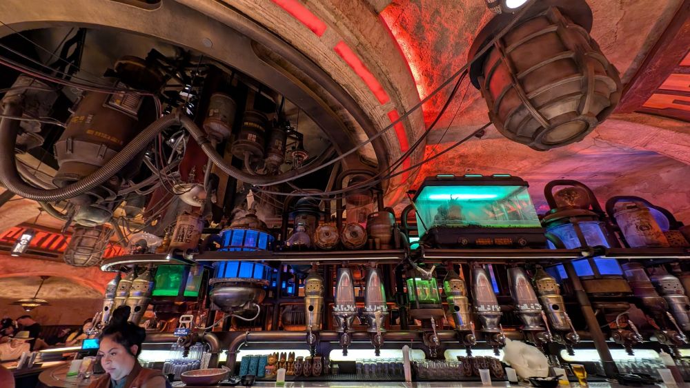 The intricate bar at Galaxy's Edge, with various alien drink dispensers and random scifi machinery hooked up to the bar's electrical systems.
