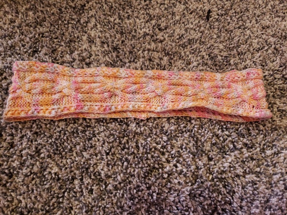 Lesbian pride knitted cable headband laid flat