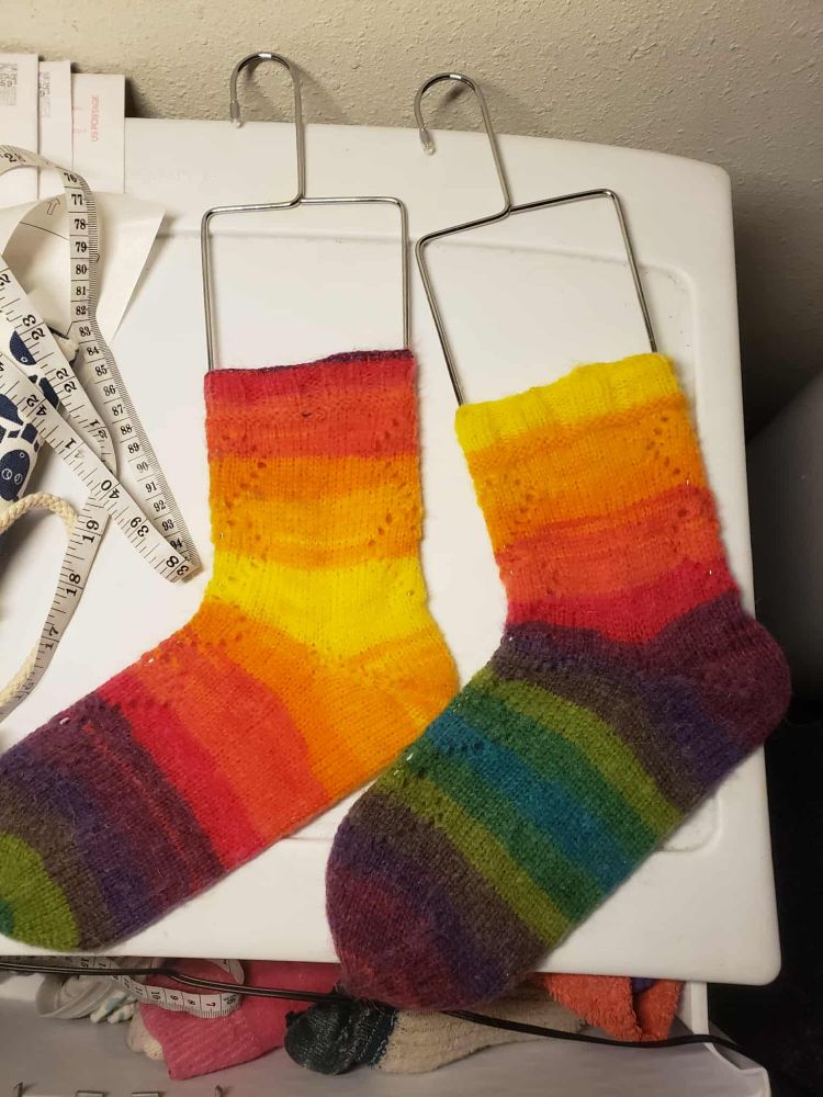 Photo of both socks laid out to block on wire blockers