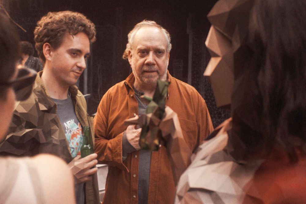 Actor Paul Giamatti and two other actors in an episode of Black Mirror.