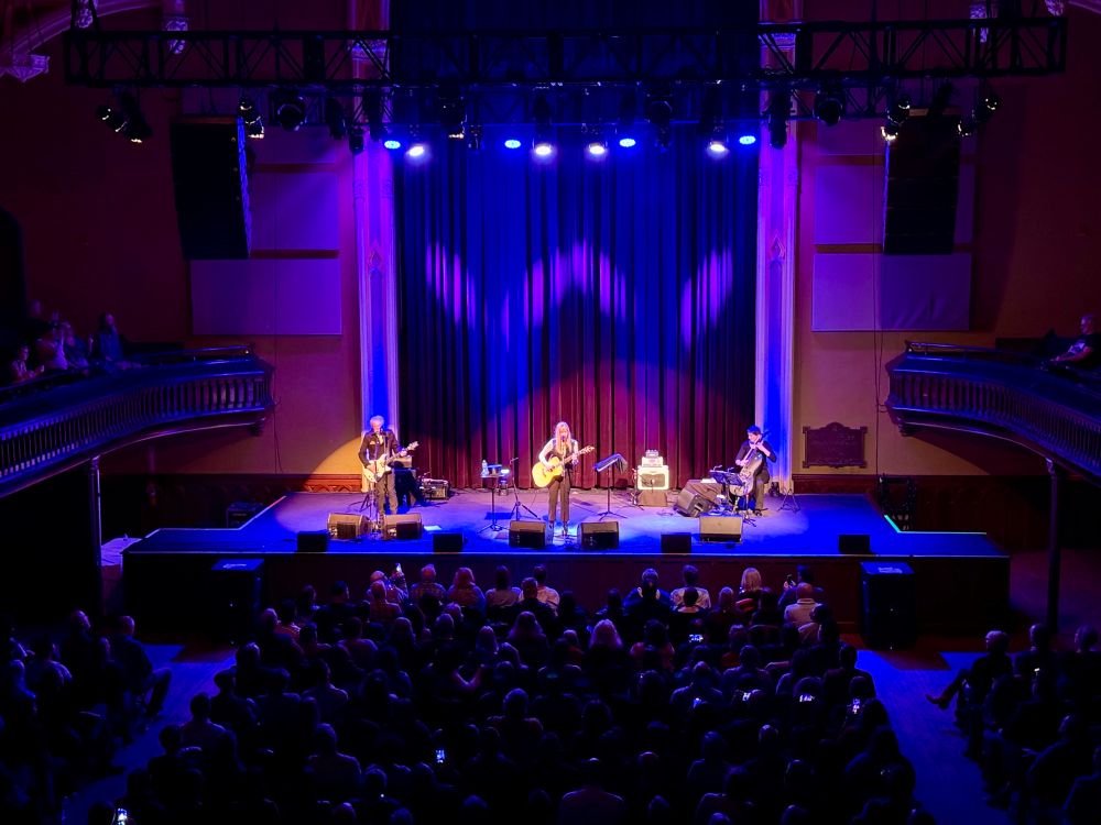 Singer Suzanne Vega, center stage, guitarist Gerry Leonard, stage left and cellist Stephanie Winters stage right perform songs on the βOld Songs, New Songs & Other Songsβ tour at Asbury Hall in Buffalo, NY.