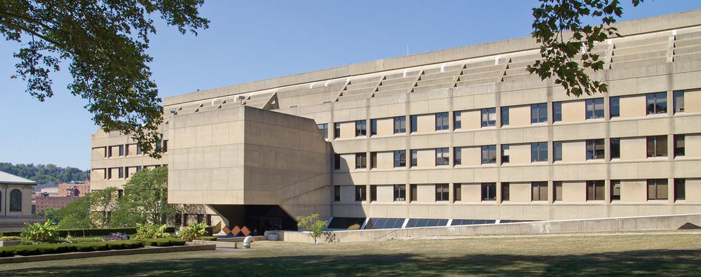 Wean Hall on Carnegie Mellon University campus. Wide, brutalist, concrete building with windows.