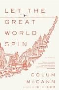 Let The Great World Spin by Colum McCann. A horizontal line spans the width of the cover between the first and second lines of the title text. Centered on the line is a tightrope walker, holding a long balance wand. An illustration of a city begins at the lower left of the cover, getting smaller and narrower as it continues to the top right of the cover. The buildings are encircled with curved lines, as if spinning. The illustration and lettering are red on a white background,