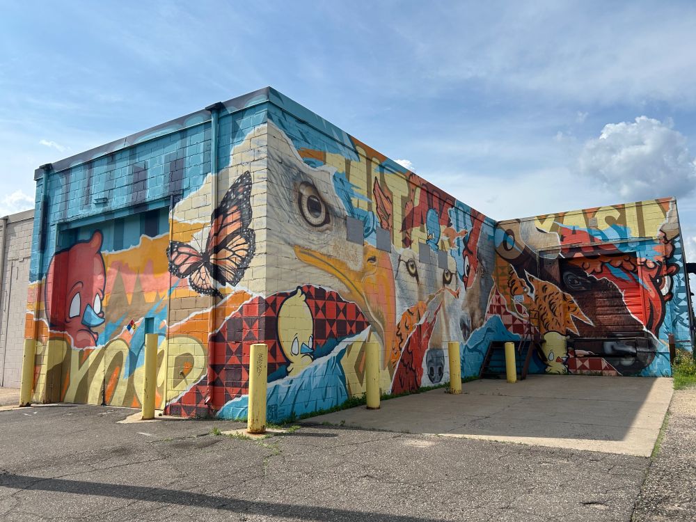 Urban art mural in St. Paul, Minnesota painted on a large industrial building. 