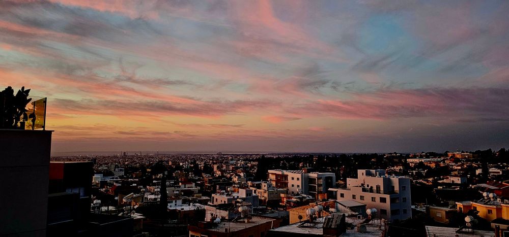 Sunrise over Western Limassol with pink and blue hues. 