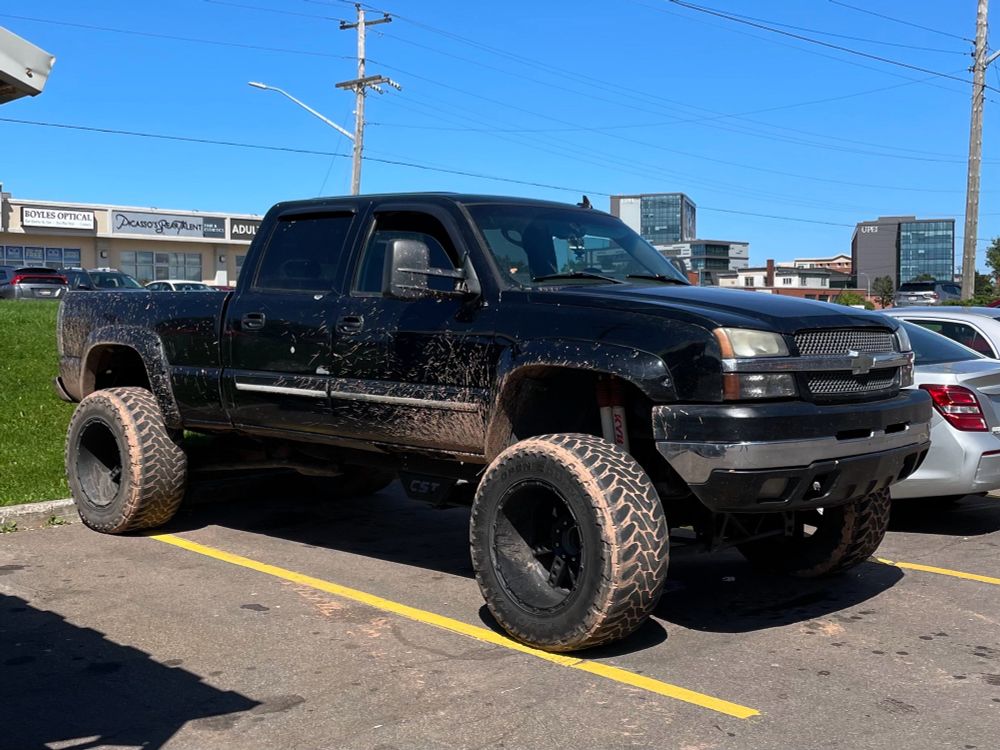 a large pickup truck with obnoxiously large tires and suspension system
