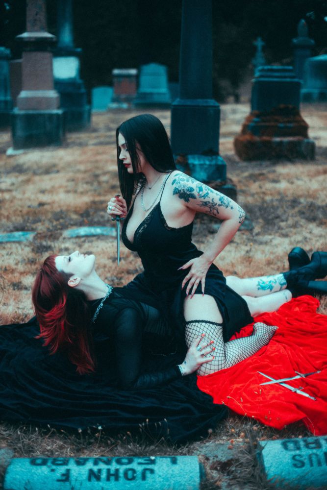 Effy on top of Stevie with a dagger, Stevie’s hands in Effy’s fishnets, Stevie sitting up as if they want Effy to bring the dagger closer  