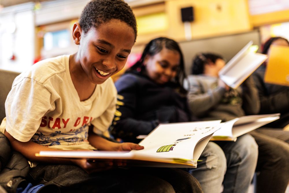 Kids excitedly read books.