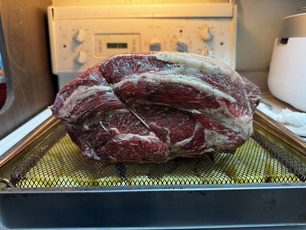 The uncooked prime rib displaying the great marbling and fat distribution