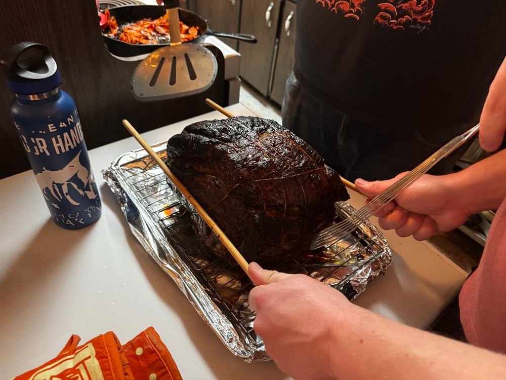 The finished prime rib being maneuvered by my partner And our longtime friend to flip