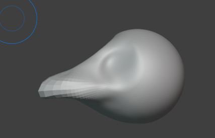 blender screenshot of a sphere with recessions for eyes and some kind of curved beak