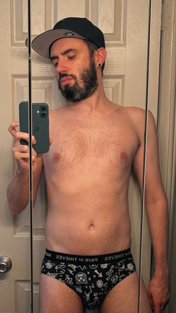 bathroom mirror selfie in patterned black briefs