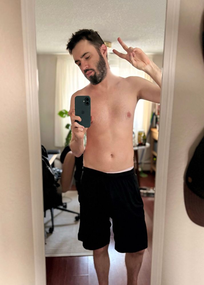 another shirtless mirror selfie of a very tired bearded man.
