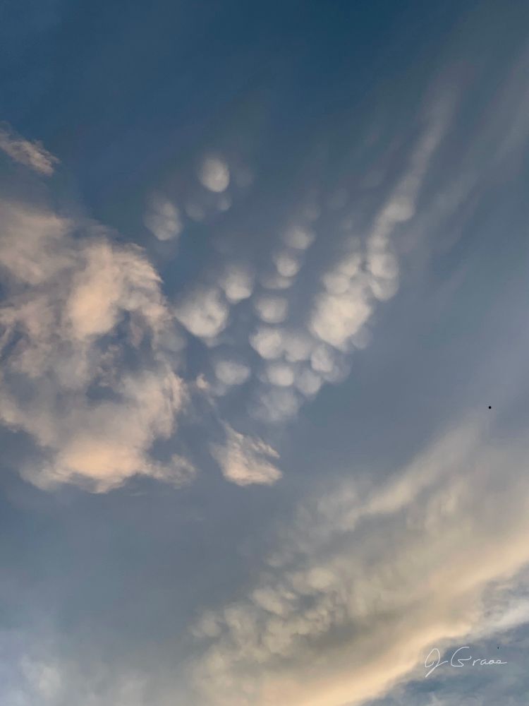 A photo of clouds, including mammatus clouds 